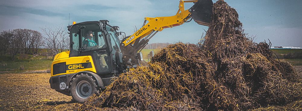 Gehl loader moving hay